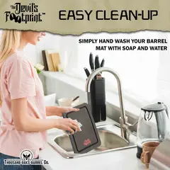 Easy clean barrel mat being hand washed in sink with soap and water for reuse.