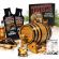 Caribbean rum aging barrel kit with oak barrel, amber rum essence packets, glass of rum, and Bootlegger’s Bible guide.
