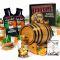 Irish single malt whiskey making kit with oak aging barrel, Dublin-style premium essence packets, Bootlegger’s Bible guide and glass of aged whiskey.
